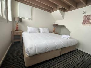 1 dormitorio con 1 cama blanca grande en una habitación en White Crystal 210 Ski In, Ski Out, en Monte Hotham