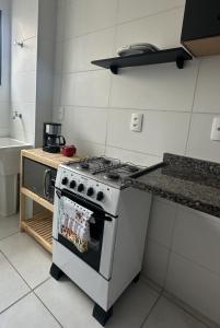 a kitchen with a stove and a counter top at Studio Garden 01 Quartos in Caruaru