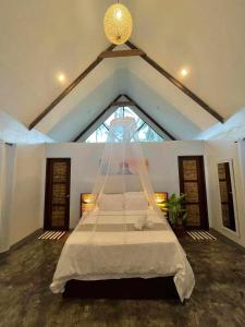 Ліжко або ліжка в номері EPBliss Villas Resort Siargao