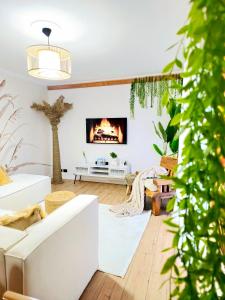 a living room with a white couch and a fireplace at Premium , Marina , Center , Beachfront in Durrës