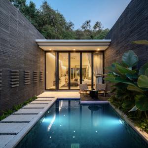 a swimming pool in the backyard of a house at Rhy.a Private Pool Villa in Ko Larn