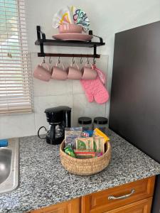 a kitchen counter with a basket of food on a counter top at Rae of Sunshine Villas in Hartswell