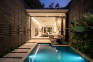 a swimming pool in the backyard of a house at Rhy.a Private Pool Villa in Ko Larn