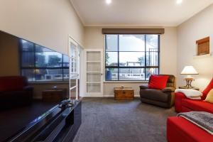 a living room with a tv and a pool table at Stella Retreat - Townhouse with pool in East Fremantle