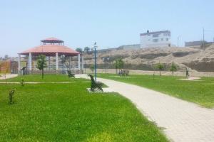 a park with a path and a gazebo in the grass at onechako101 in Víctor Larco Herrera