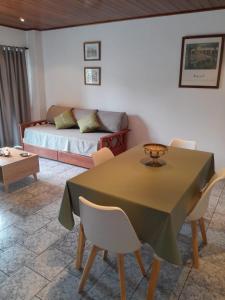 a living room with a table and a couch at Departamento La Plaza in La Falda