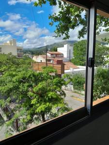 a window with a view of a city at Departamento La Plaza in La Falda