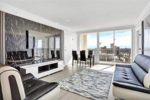 a living room with a blue couch and a mirror at Amazing 1 Bedroom&1Bath OCEAN-VIEW Condo in Daytona Beach