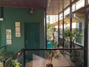 a green house with a green door on a balcony at Coqueto departamento in Puerto Iguazú