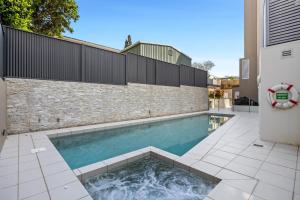a swimming pool in the middle of a house at Beachside Stunning 3-Bed with Ocean View & Pool in Caloundra