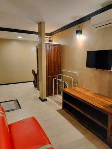 a living room with a couch and a flat screen tv at Perry Barr La Ganta Residence in Temerloh