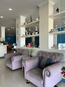 a living room with two couches and a table at Ancora Y&W Boutique Hotel in Ao Nang Beach