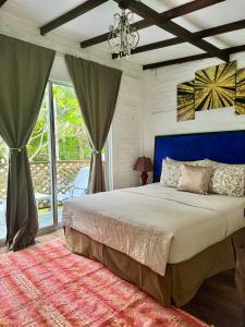 a bedroom with a large bed with a blue headboard at Eagleye Langkawi in Tanjung Rhu