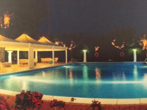a swimming pool at night with a pavilion at Oscar e Amorina in Montegiorgio