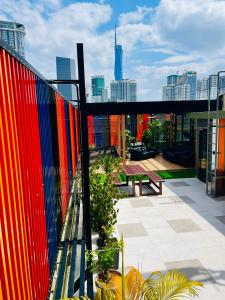 a balcony with a colorful fence and a bench at ESSY Hotel KL Sentral in Kuala Lumpur