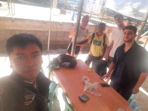 a group of men standing around a table at Hiker's Homestay in Banaue