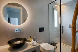 a bathroom with a black bowl sink and a shower at Villa Mirage - Super Paradise beach in Mýkonos City +50 photos