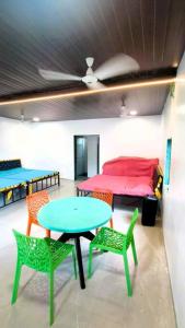 a room with a table and chairs and a bed at Mumbai Oasis in Thane