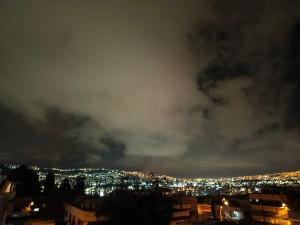 a view of a city at night at Casa relax in Quito