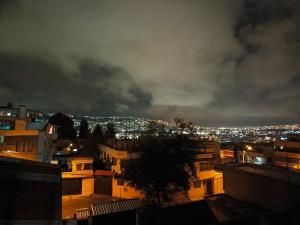 a view of a city at night at Casa relax in Quito