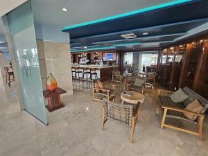 a restaurant with chairs and tables and a bar at Mare-1708 B in Aventura