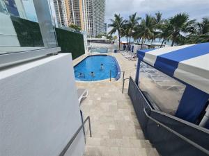 a view of a swimming pool from the balcony of a resort at Mare-1708 B in Aventura