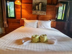 Ένα ή περισσότερα κρεβάτια σε δωμάτιο στο Amarit Onsen Homestay +44 φωτογραφίες