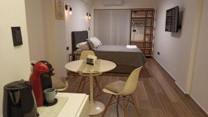 a small room with a bed and a table and chairs at Palermo Vibes, All in walking distance in Buenos Aires