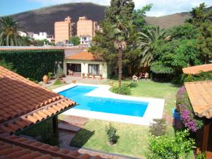 a swimming pool in the yard of a house at Hotel Boutique La Candela in Salta