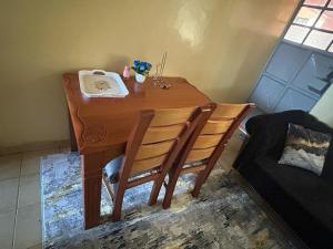 a wooden table with a phone on top of it at Tenet Upper Kabete Homes in Nairobi