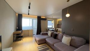 a living room with a couch and a kitchen at 2 room Modern Apartment in Dnipro