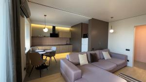 a living room and kitchen with a couch and a table at 2 room Modern Apartment View in Dnipro