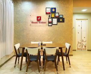 a dining room with a wooden table and chairs at Amadel Residence 爱媄德民宿 1314 in Melaka