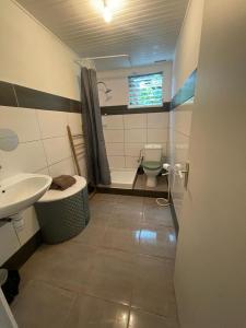 a bathroom with a toilet and a sink at Lamary au François avec SPA in Le François