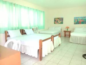 a room with two beds and a window at Aglicay Beach Resort in Romblon