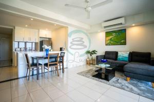 a living room with a couch and a table at Zen Ocean Pebble 1-BR/1-BA Sea View Retreat in Darwin
