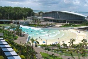a pool at a resort with people swimming in it at Zen Ocean Pebble 1-BR/1-BA Sea View Retreat in Darwin