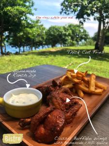 a plate of food with meat and french fries at The LivingSpace Villa in Camotes Islands