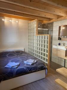 a bedroom with a bed and a wine cellar at La Gardette in Le Freney-dʼOisans