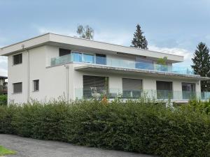 a white house with a lot of windows at Attika Loft Wohnung 3.5 Zi. 110m2 Neu Bau in Obergösgen