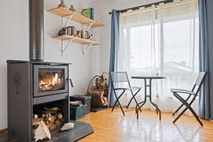 a living room with a fireplace and a table at Old Sea Dog's Retreat in Coronet Bay