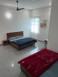 a bedroom with a large bed and a window at Prem Bhawan Guest House in Khātu