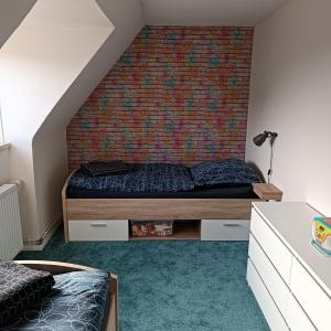 Un dormitorio con una cama y una pared de ladrillo. en Haus Irma, en Hemmingstedt