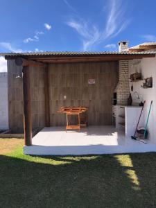 a patio with a wooden table and a table at Recanto Arvoredo in Entre Rios