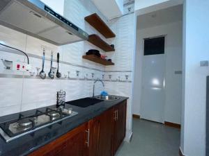 a kitchen with a sink and a counter top at Stylish 1-Bedroom Apartments with Amazing Views in Dar es Salaam