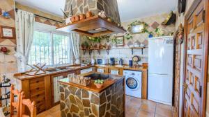 a kitchen with a refrigerator and a dishwasher at Villa Cereza Antequera - La Higuera by Ruralidays in Antequera
