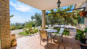 a patio with a table and chairs and a view at Villa Cereza Antequera - La Higuera by Ruralidays in Antequera