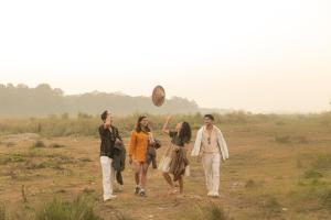 a group of people walking in a field at Kasara Chitwan in Chitwan