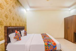 1 dormitorio con 1 cama en una habitación en FabExpress Grand Inn, en Vibhuti Khand