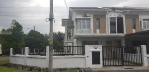 a house with a white fence in front of it at Teratak Teratai Homestay- Corner in Semenyih